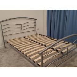 Metal standard double bed frame with slatted base and one matching bedside table, good condition