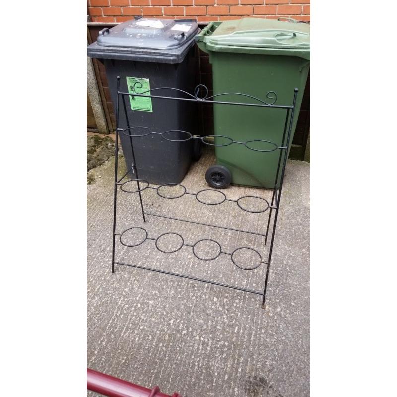 black metal stand to hold flower buckets